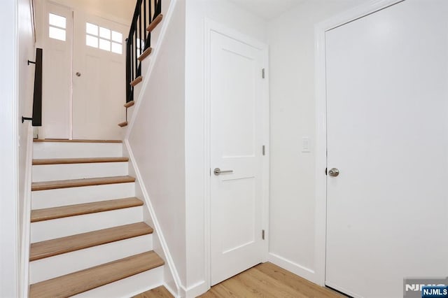 stairs featuring wood finished floors