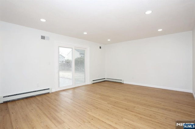 unfurnished room with a baseboard heating unit, recessed lighting, and light wood-style floors