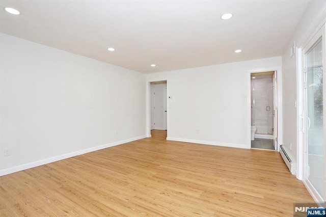 unfurnished room with light wood-type flooring, a baseboard radiator, baseboards, and recessed lighting