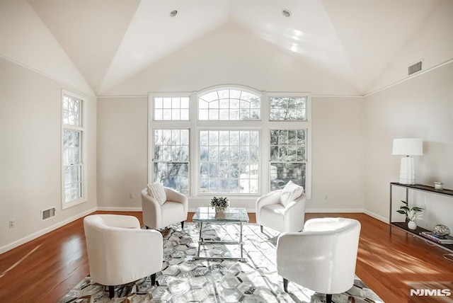 sitting room featuring baseboards, visible vents, and wood finished floors