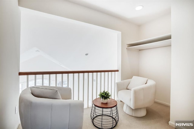 sitting room with carpet floors and recessed lighting