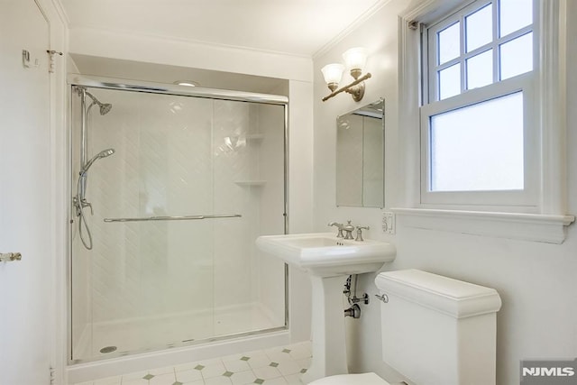 full bath featuring toilet, a shower stall, ornamental molding, and tile patterned floors