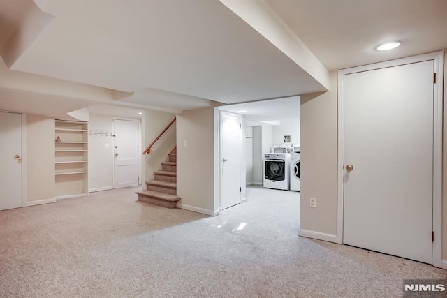 finished basement with carpet floors, stairway, washer and clothes dryer, and baseboards