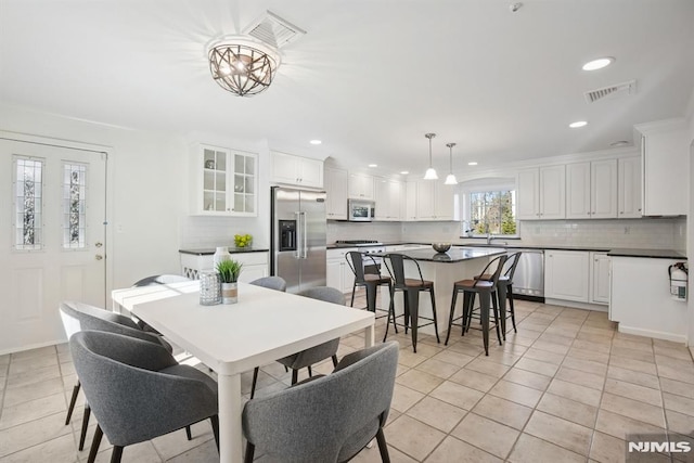 dining space featuring light tile patterned floors, visible vents, and recessed lighting