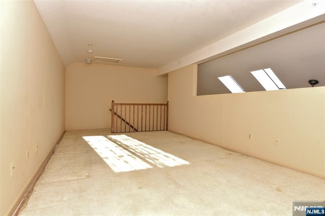 additional living space featuring carpet and vaulted ceiling