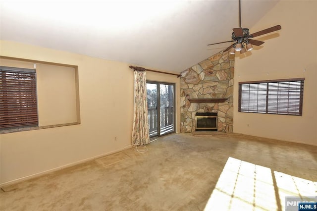 unfurnished living room featuring ceiling fan, a fireplace, high vaulted ceiling, and carpet