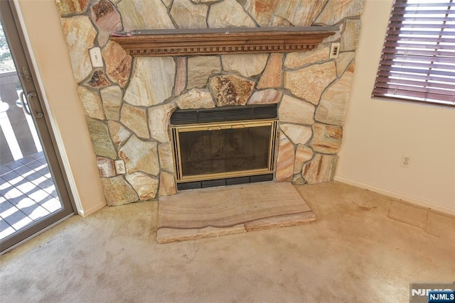 room details featuring baseboards, carpet, and a fireplace