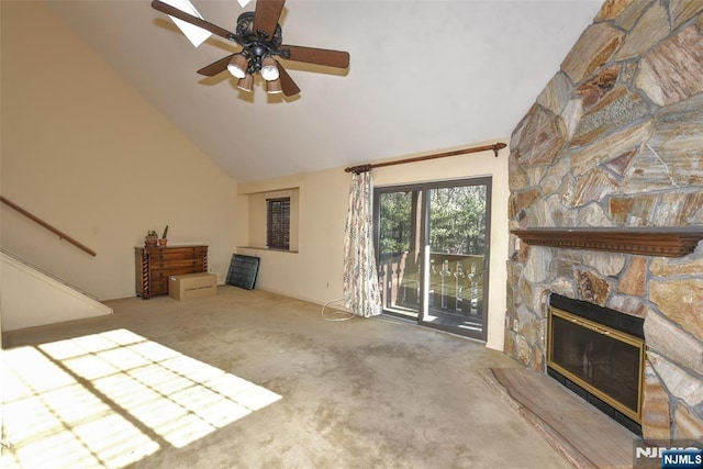 unfurnished living room featuring ceiling fan, stairs, carpet flooring, a fireplace, and high vaulted ceiling