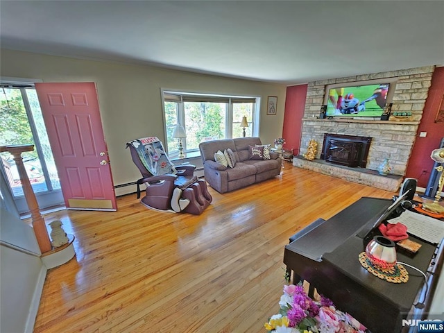 living area with baseboard heating and wood finished floors