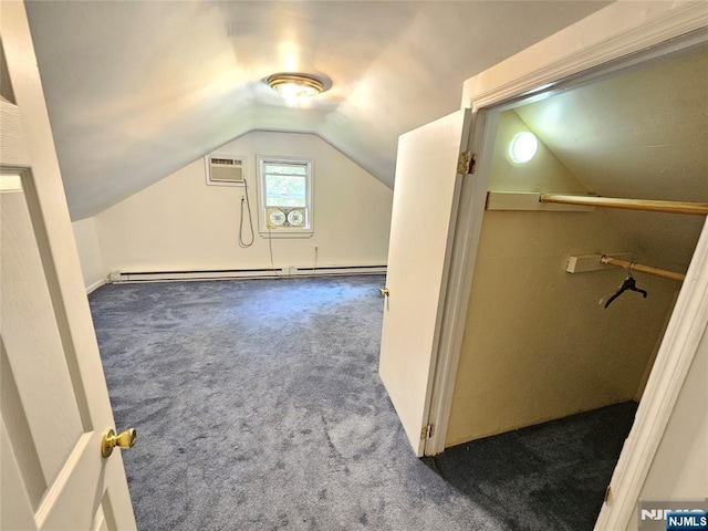 additional living space featuring a baseboard radiator, carpet flooring, and vaulted ceiling