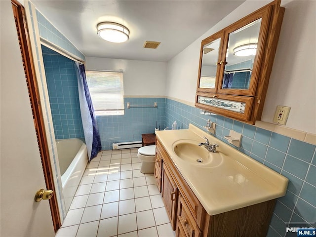 full bath with visible vents, toilet, tile patterned flooring, a baseboard heating unit, and tile walls