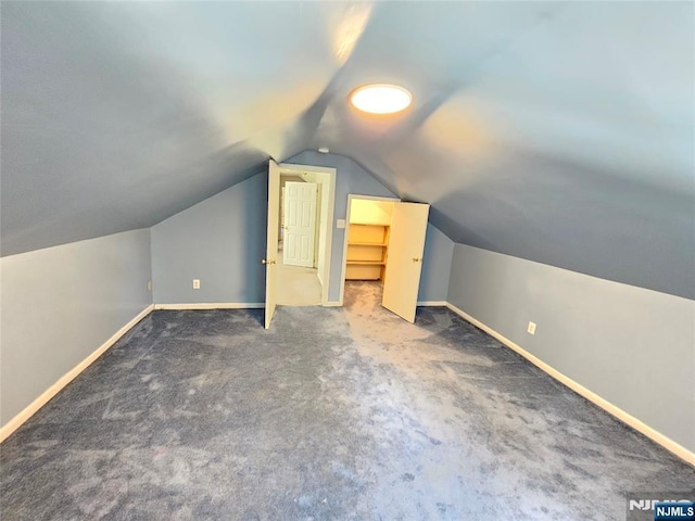 additional living space with lofted ceiling, carpet flooring, and baseboards