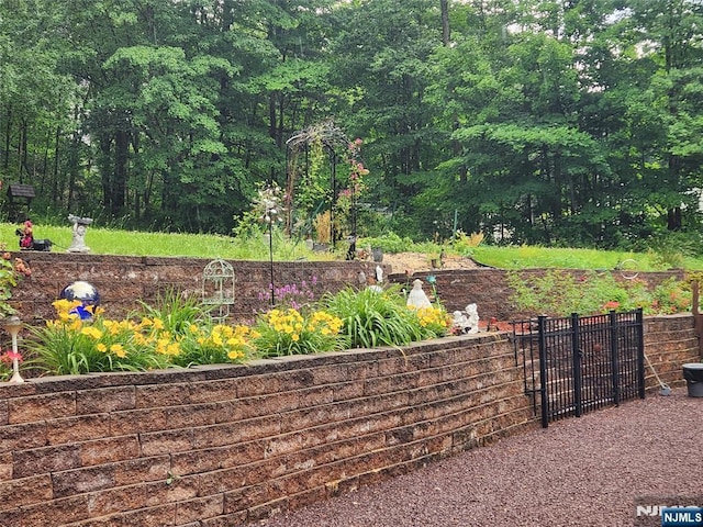 view of yard with fence and a view of trees