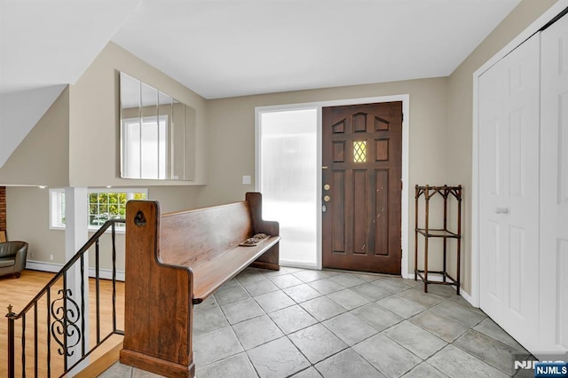 foyer entrance with light tile patterned flooring and baseboards