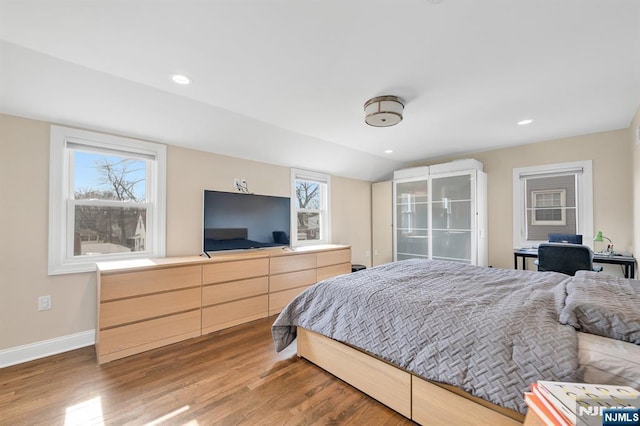 bedroom with lofted ceiling, baseboards, wood finished floors, and recessed lighting