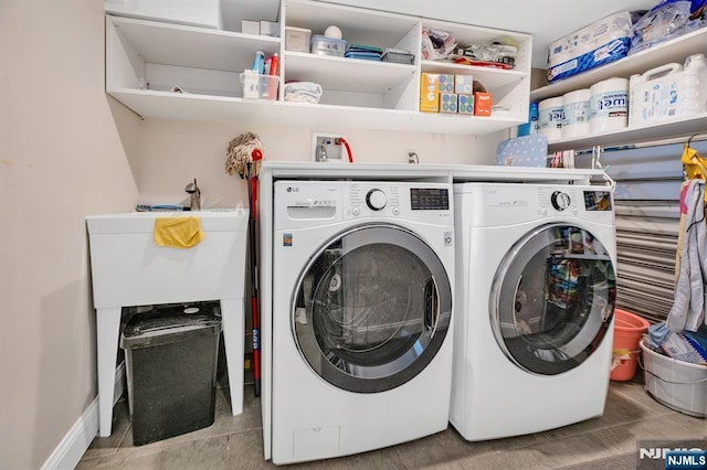 washroom with tile patterned flooring, laundry area, and washer and clothes dryer