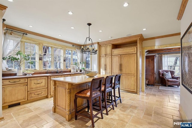 kitchen with recessed lighting, stone tile floors, a breakfast bar, ornamental molding, and open shelves