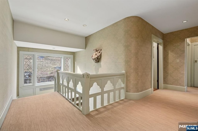 corridor featuring recessed lighting, carpet flooring, and baseboards