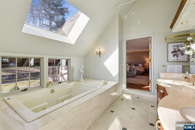 bathroom featuring double vanity, a sink, ensuite bath, vaulted ceiling with skylight, and a jetted tub