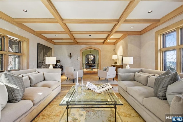 living room featuring arched walkways, coffered ceiling, and beamed ceiling