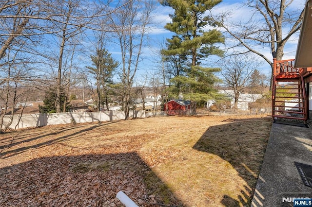 view of yard featuring stairway and fence