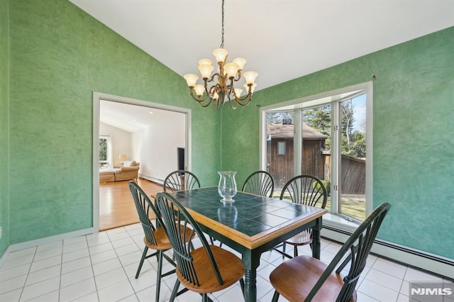 dining space with plenty of natural light, a notable chandelier, light tile patterned flooring, and vaulted ceiling