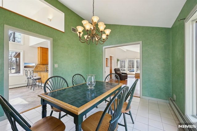 dining space with light tile patterned floors, baseboard heating, visible vents, and a baseboard radiator