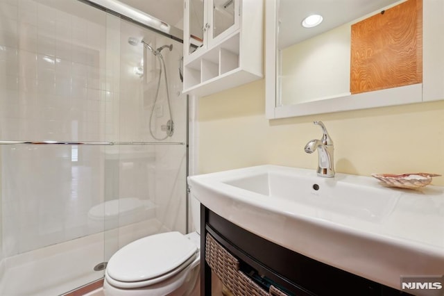 full bath with recessed lighting, vanity, toilet, and a shower stall