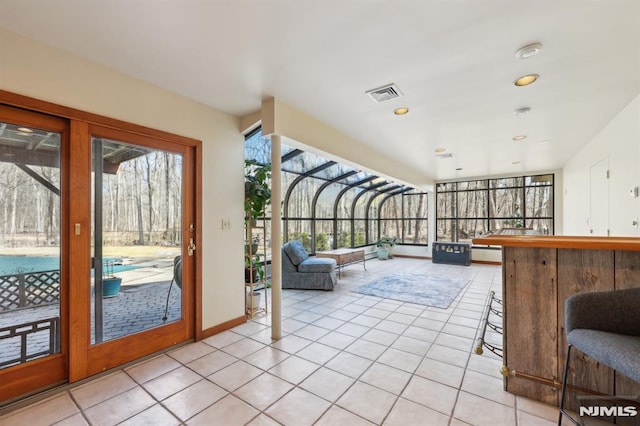 unfurnished sunroom featuring visible vents and a healthy amount of sunlight