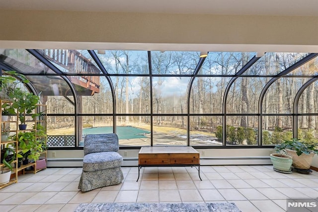 unfurnished sunroom featuring a baseboard heating unit