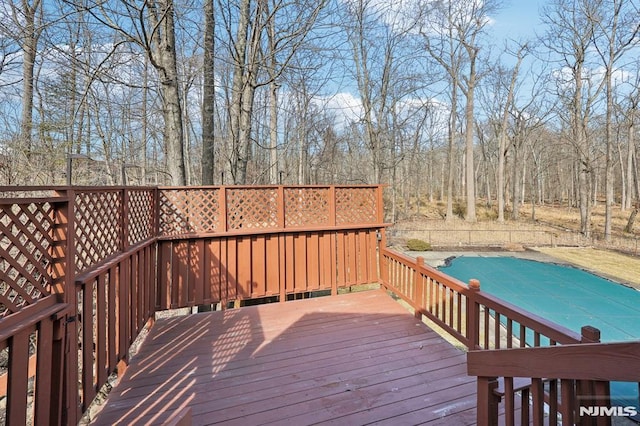 deck featuring a fenced in pool