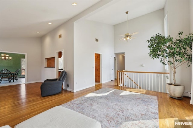 living room featuring recessed lighting, wood finished floors, baseboards, and baseboard heating