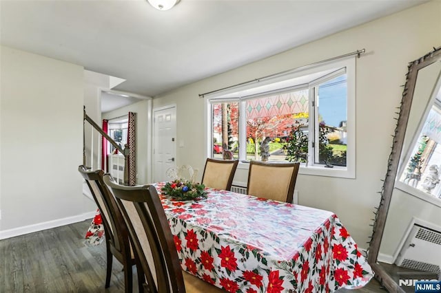 dining area featuring stairs, dark wood-type flooring, and baseboards