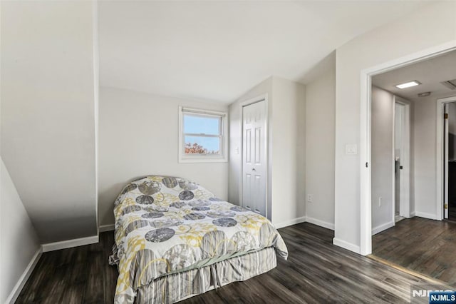 bedroom featuring a closet, baseboards, and wood finished floors