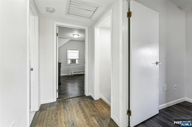 corridor featuring cooling unit, a baseboard heating unit, baseboards, wood-type flooring, and attic access