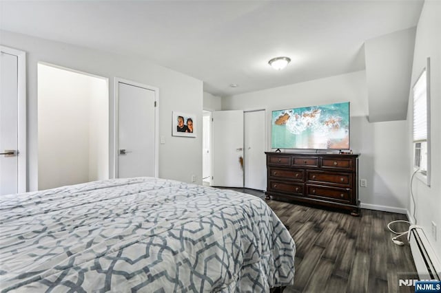 bedroom with dark wood-type flooring, a baseboard radiator, and baseboards