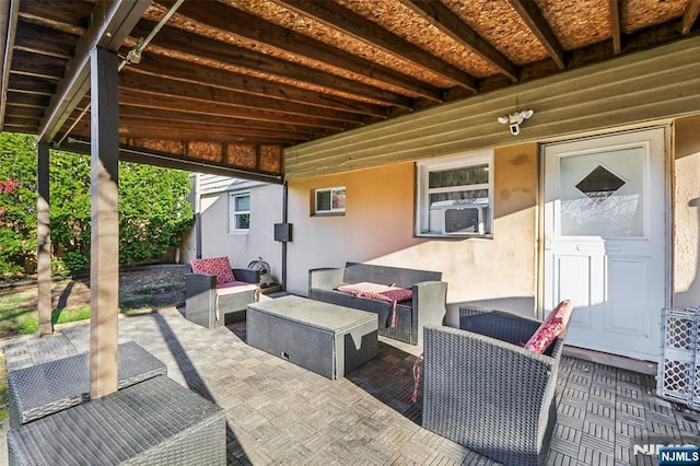 view of patio / terrace with cooling unit and an outdoor living space