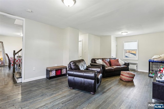 living room with stairway, radiator heating unit, wood finished floors, and baseboards