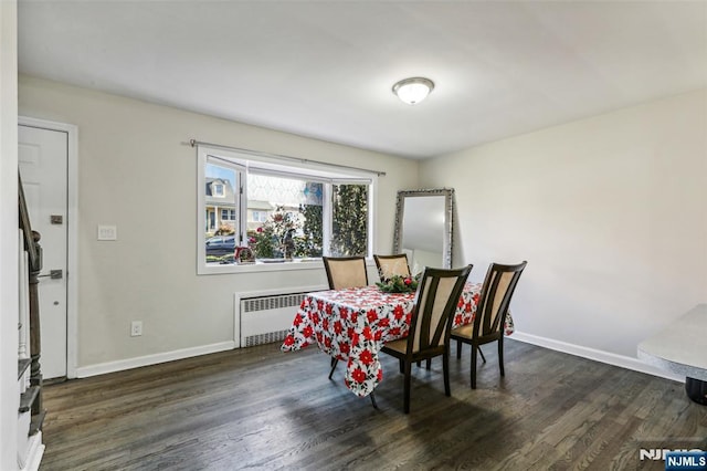 dining space featuring radiator, baseboards, and dark wood-type flooring