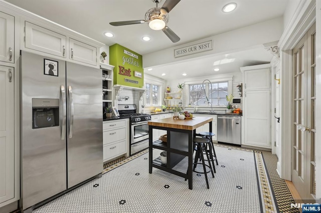 kitchen with stainless steel appliances, recessed lighting, white cabinetry, and open shelves