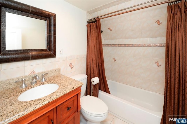 bathroom with toilet, vanity, tile walls, and shower / tub combo with curtain