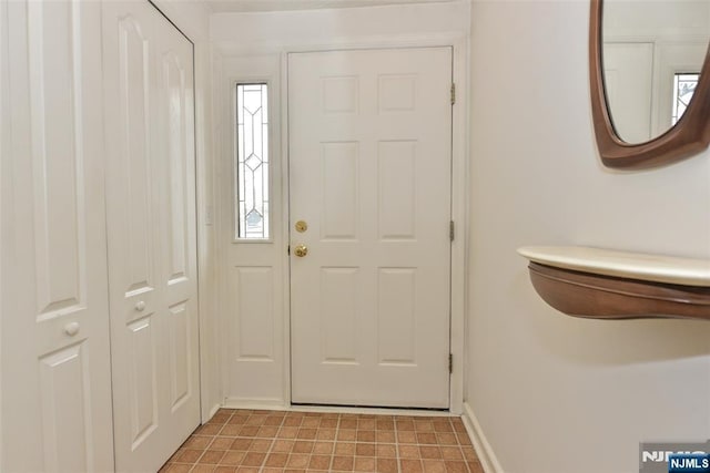 foyer featuring baseboards