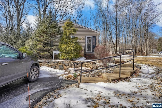 view of snowy exterior featuring entry steps