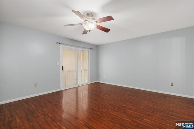 spare room featuring visible vents, ceiling fan, baseboards, and wood finished floors