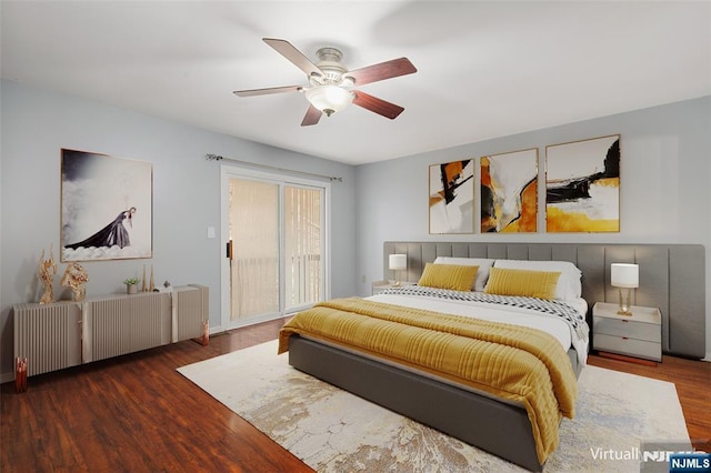 bedroom featuring radiator heating unit, wood finished floors, a ceiling fan, and access to exterior