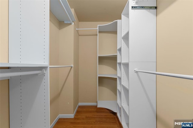 spacious closet with wood finished floors