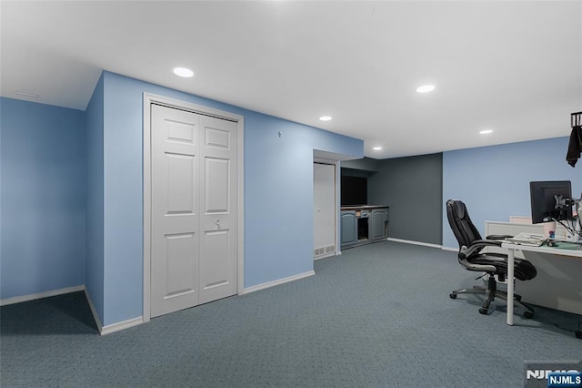 unfurnished office with carpet floors, baseboards, and recessed lighting