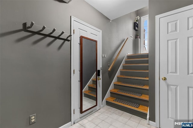 stairs with tile patterned floors