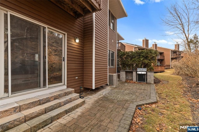 view of patio with entry steps, a grill, and exterior kitchen