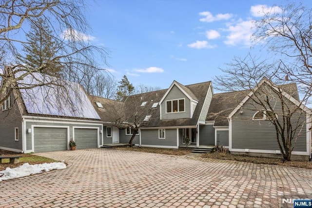 view of front of property featuring a garage and decorative driveway